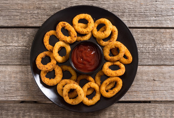 Crunchy fried onion rings and ketchup