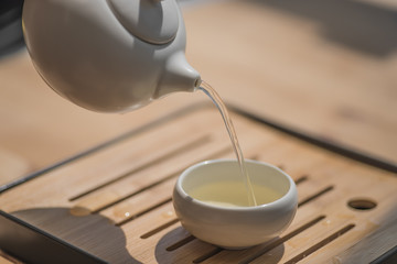 Chinese tea ceremony, asian traditional culture. White tea set on a wooden background.