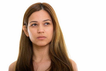 Studio shot of young beautiful woman thinking while looking up