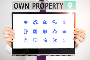Word writing text Own Property. Business photo showcasing Things that you own and can take it with you Movable Tangible Male human holding thick textured cardboard of business promotion concept