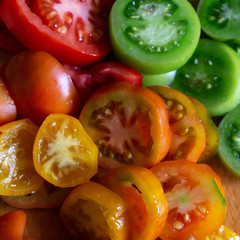 Food Background. Sliced yellow, red and green tomatoes