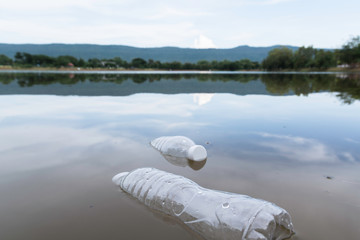 Plastic water bottles pollution in the river. Plastic trash in water. Environmental pollution...