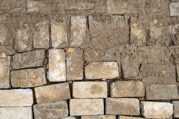 Footprint and Bike car motorcycle Tire track marks in the muddy roads wetlands. Trail on dirt road texture. Back background. Tyre tracks on dirt candy mod soul grunge tone with love tiles