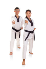 Two young energetic martial art practitioners full length