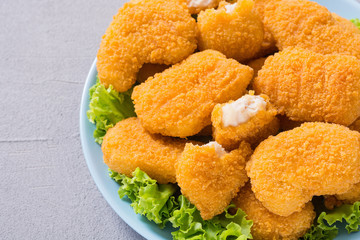 Chicken nuggets in plate on rustic background