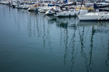 boats in marina with reflections in water in Cascais