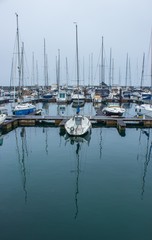 Fototapeta na wymiar boats in marina with reflections in water