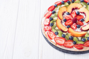Fruit pizza with fruit and berries .