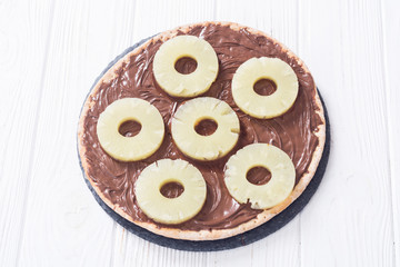Fruit pizza with nut nougat cream and pineapple