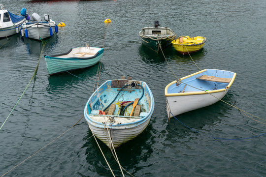 Small Tender Boats Moored And Floating At High Tide In Cornwall