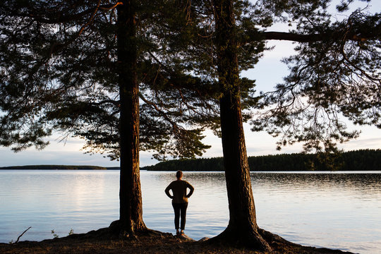 Mature woman standing next to lake