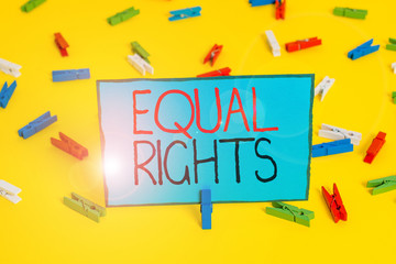 Text sign showing Equal Rights. Business photo showcasing Equality before the law when all showing have the same rights Colored clothespin papers empty reminder yellow floor background office