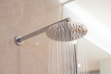 Shower turned on, overhead ceiling shower faucet head closeup. - obrazy, fototapety, plakaty