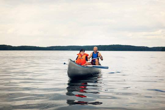 Father and son canoeing on lake