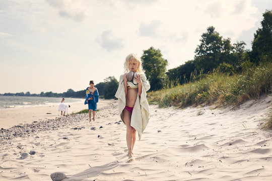 Girl carrying rocks on beach