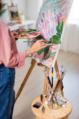 art, creativity and inspiration concept - close up of female hands  painting at home