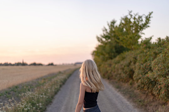 Teenage girl standing on rural road