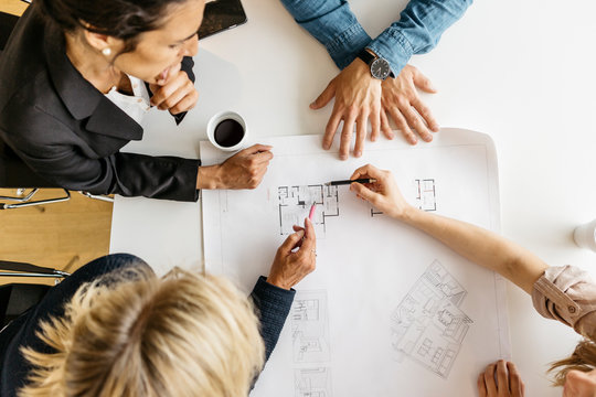 Businesspeople looking at plans during meeting
