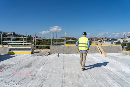Construction worker on roof of incomplete building