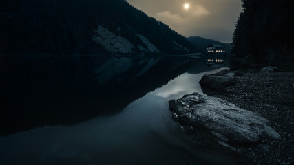 night landscape with mountain lake and refuge
