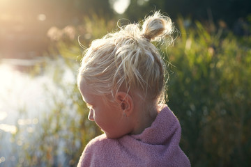 Profile of girl with her hair tied back