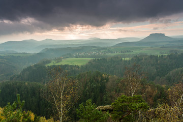 View of the Lilienstein Plateau. Autuum mood with dark clouds, Elbstandstein mountains landscape. Traveling in East Germany.