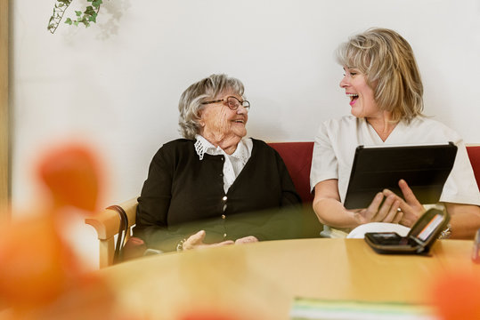 Senior woman learning to use tablet PC