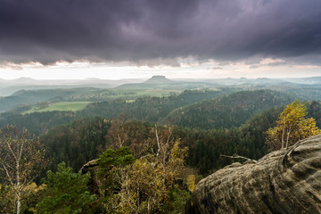 View of the Lilienstein Plateau. Autuum mood with dark clouds, Elbstandstein mountains landscape....