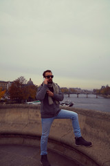 Fototapeta na wymiar Handsome man enjoying in Paris while using cellphone.