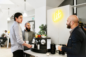 Men getting coffee in office