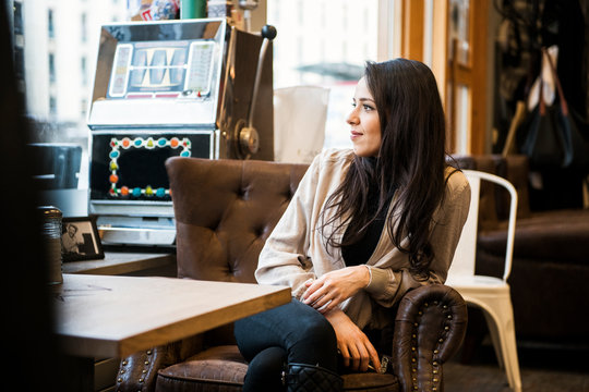 Young woman sitting at table in barbershop