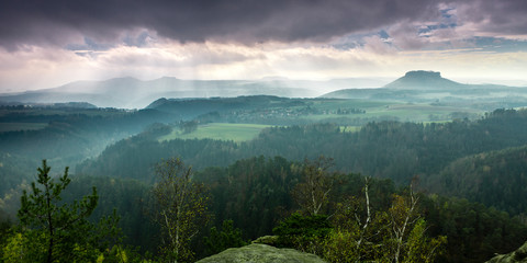 View of the Lilienstein Plateau. Autuum mood with dark clouds, Elbstandstein mountains landscape. Traveling in East Germany.