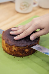 Making a layer cake. Cutting the top off of cakes with a serrated knife to level cake.
