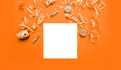 Notebook  with golden bow on orange monochrome festivel background with stars and sparkles wish list . New year resolution concept copyspace top horizontal view. Sticky tape, Christmas balls
