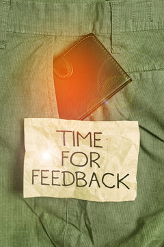 Word writing text Time For Feedback. Business photo showcasing information about reactions to a product or services Small little wallet inside man trousers front pocket near notation paper