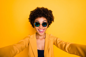 Close up photo of funny funky girl make selfie lick her lips have journey trip leisure time wear stylish fashionable suit isolated over yellow color background
