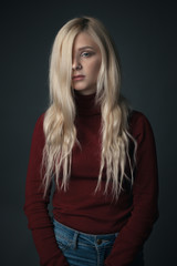 Portrait of young woman with beautiful blonde hair. Studio
