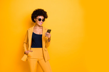 Portrait of charming cool afro american lady use her smartphone communicate with followers in blog...