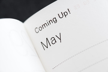 Coming Up! May, months of a year. Macro shot of a monthly planner.