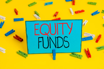 Text sign showing Equity Funds. Business photo showcasing type of mutual fund that buys ownership in businesses Colored clothespin papers empty reminder yellow floor background office
