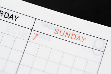 Obraz premium Sunday, days of the week. Macro shot of monthly planner - Image