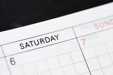 Obraz premium Saturday, days of the week. Black and white macro shot of monthly planner - Image