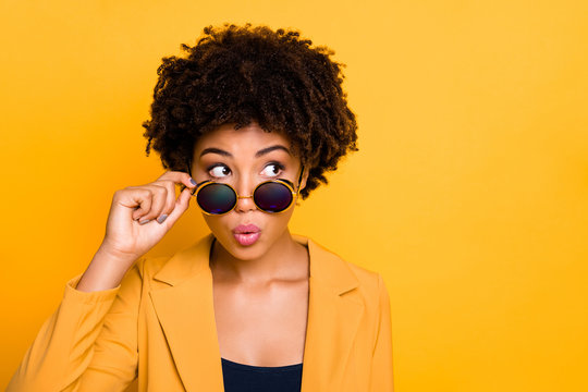 Close-up portrait of her she nice-looking attractive lovely wondered wavy-haired girl touching specs looking aside isolated over bright vivid shine vibrant yellow color background