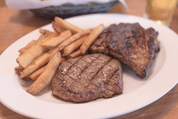 Rib eye Steak and Ribs with Potato Fries.