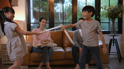 Fototapeta premium Holiday concept. Father and mother are watching fencing in the living room. 4k Resolution.
