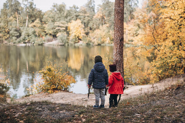 Fototapeta premium two kids walking in autumn forest
