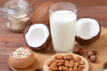 Different types of vegetable milk on the table. Coconut, oatmeal, hazelnut, almond milk. Vegetarian milk.