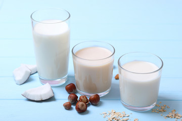 Different types of vegetable milk on the table. Coconut, oatmeal, hazelnut, almond milk. Vegetarian milk.