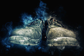 workers safety shoes on black background - hard work concept