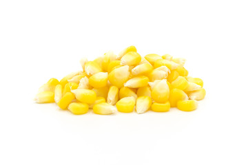 Piles of fresh corn kernels close-up isolated on white background